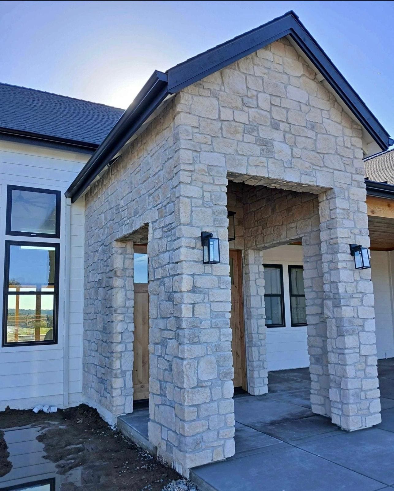 Stone veneer porch entry with square columns and a flat lintel