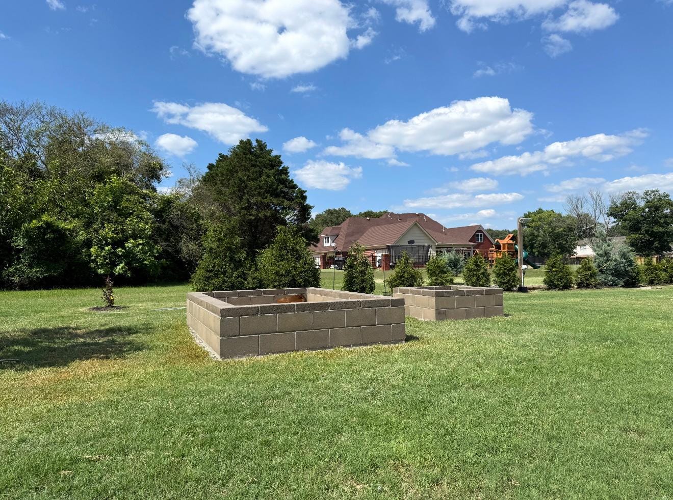 Two block raised garden beds set on a lawn