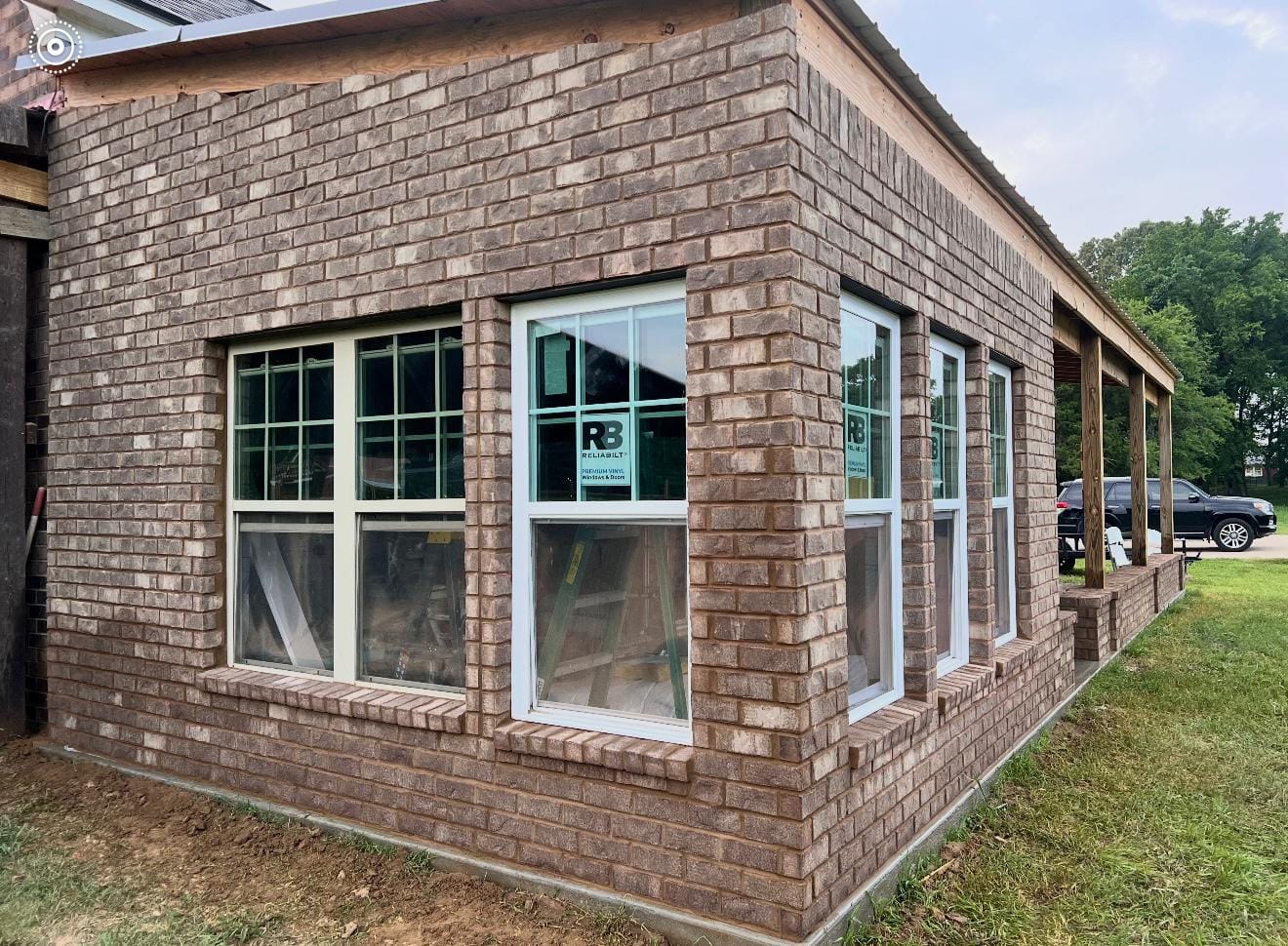 Brick veneer elevation running the length of a house with window openings