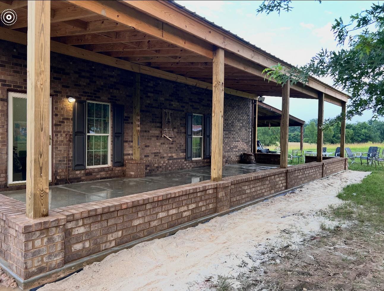 Covered porch with a brick knee wall, brick columns and timber posts