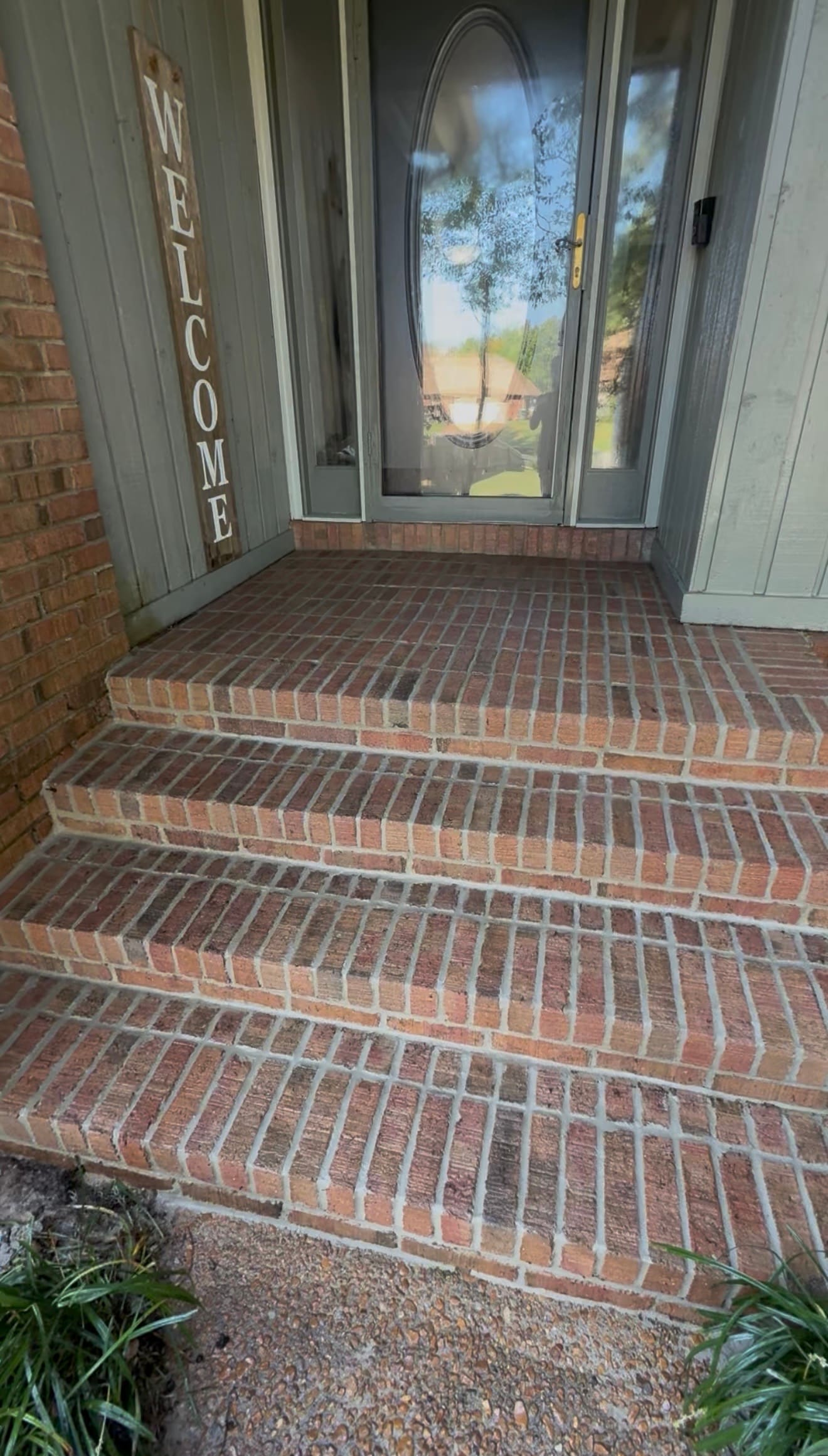 Brick entry steps with brick treads leading up to a front door